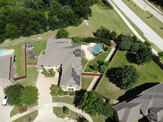 an aerial view of a house with a yard and trees
