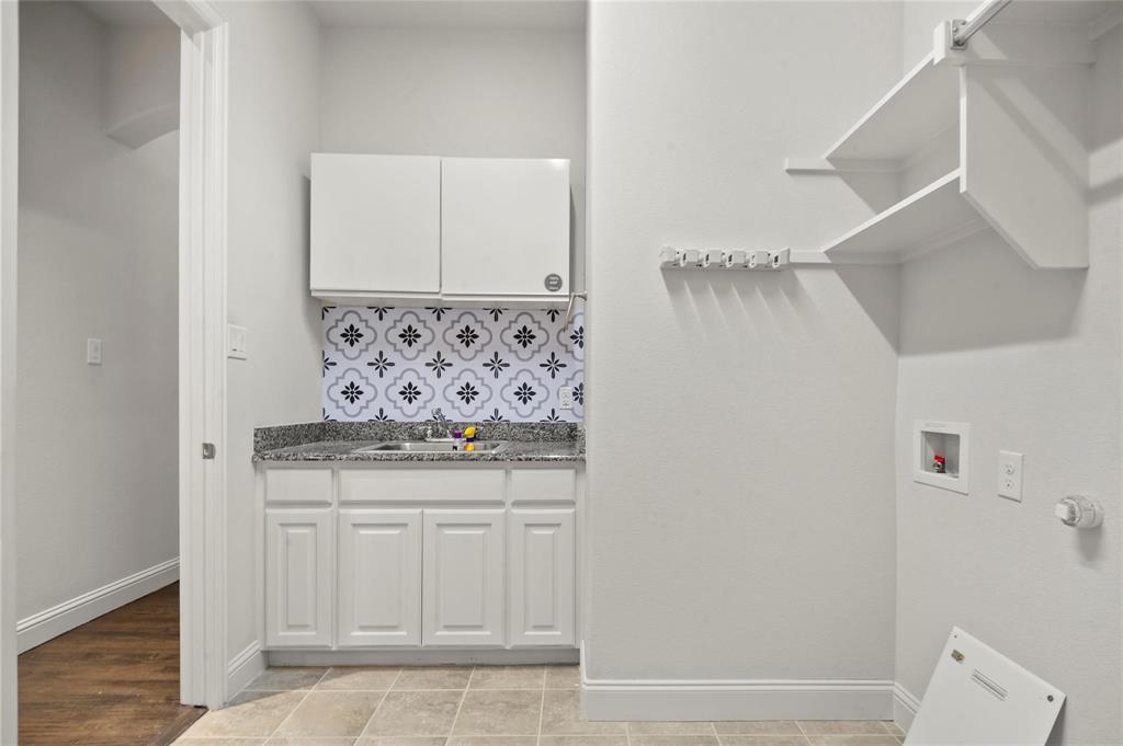 13606 Crianza Road Frisco, TX 75035 - Photo 26 of 40 a bathroom with a granite countertop sink and a mirror
