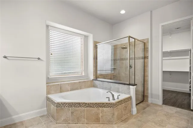 a bathroom with a tub and a shower