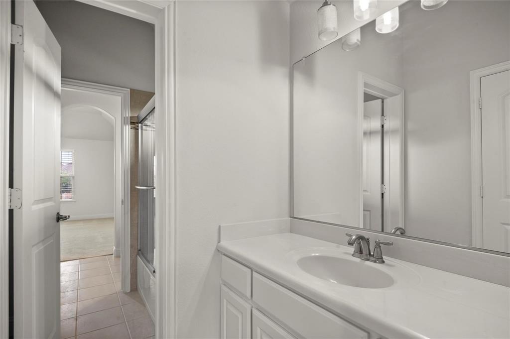 13606 Crianza Road Frisco, TX 75035 - Photo 33 of 40 a bathroom with a sink and a mirror