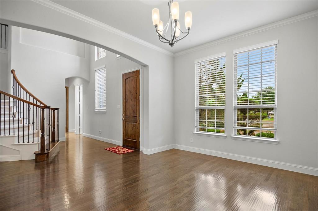 13606 Crianza Road Frisco, TX 75035 - Photo 6 of 40 a view of an empty room with wooden floor and a window
