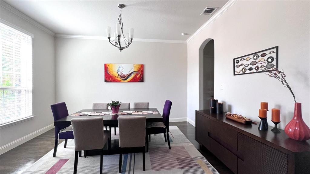 13606 Crianza Road Frisco, TX 75035 - Photo 8 of 40 a view of a dining room with furniture a chandelier and wooden floor