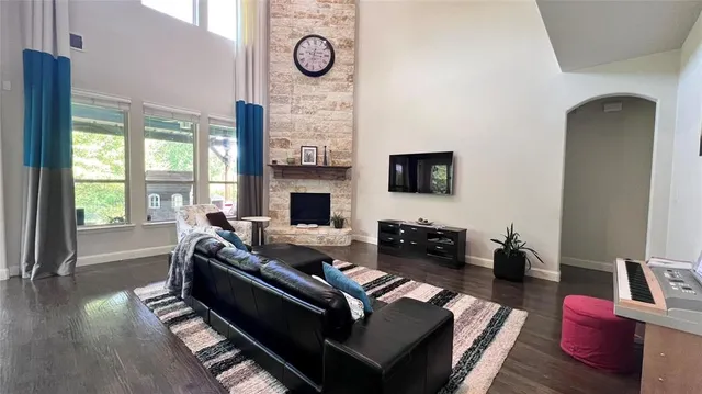 a living room with furniture fireplace and wooden floor