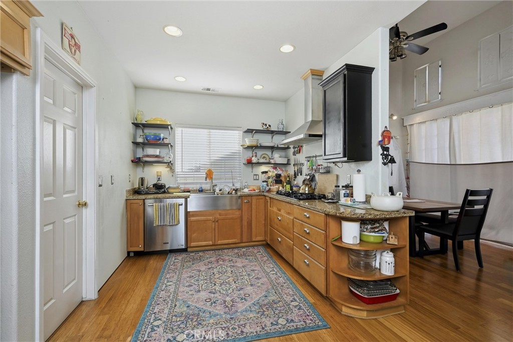 17905 Bunker Road Hidden Valley Lake, CA 95467 - Photo 8 of 28 Up to date kitchen with granite countertops, farm sink and 5 burner propane stove with efficient hood.
