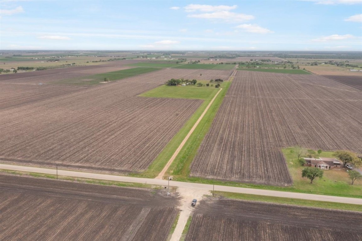 13339 Bj Dusek Road Wallis, TX 77485 - Photo 32 of 39 Expansive rural property with vast open fields and a long driveway leading to a secluded home. Ideal for privacy and agricultural opportunities.
