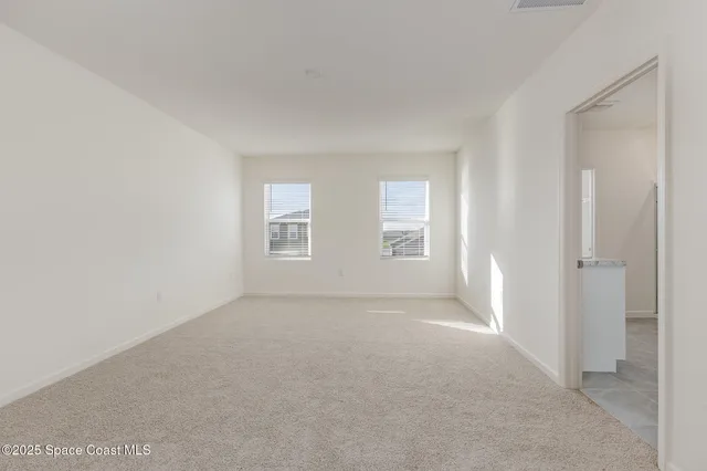 a view of empty room with windows