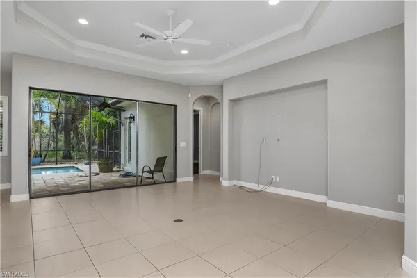 an empty room with floor to ceiling windows and an outdoor view