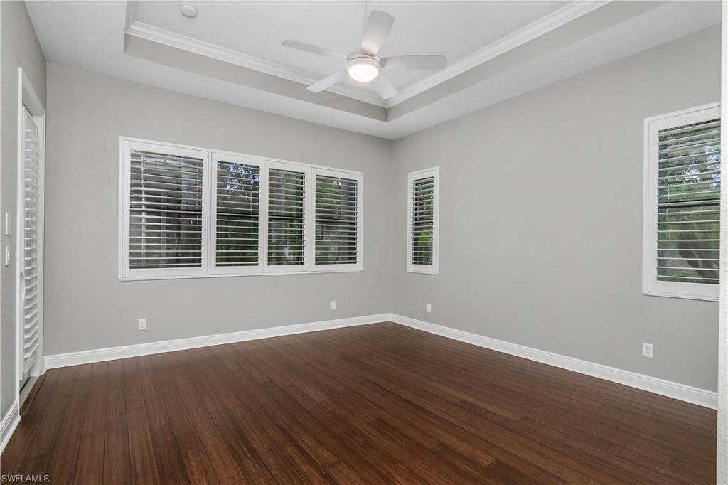 1558 Serrano Circle Naples, FL 34105 - Photo 13 of 31 a view of wooden floor and windows in a room