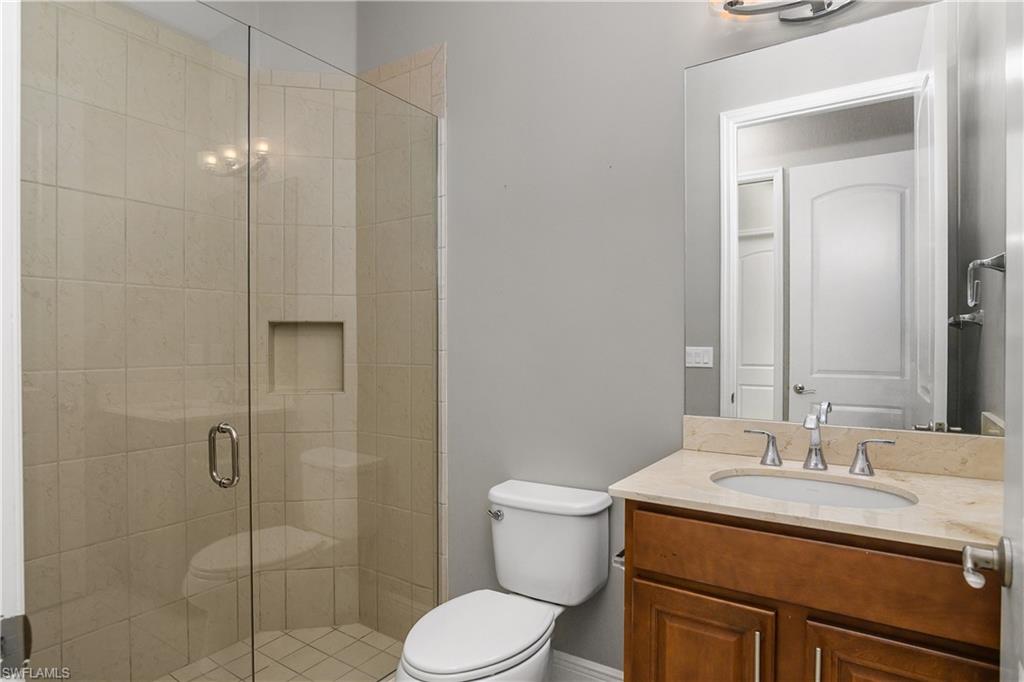 1558 Serrano Circle Naples, FL 34105 - Photo 21 of 31 a bathroom with a sink toilet and shower