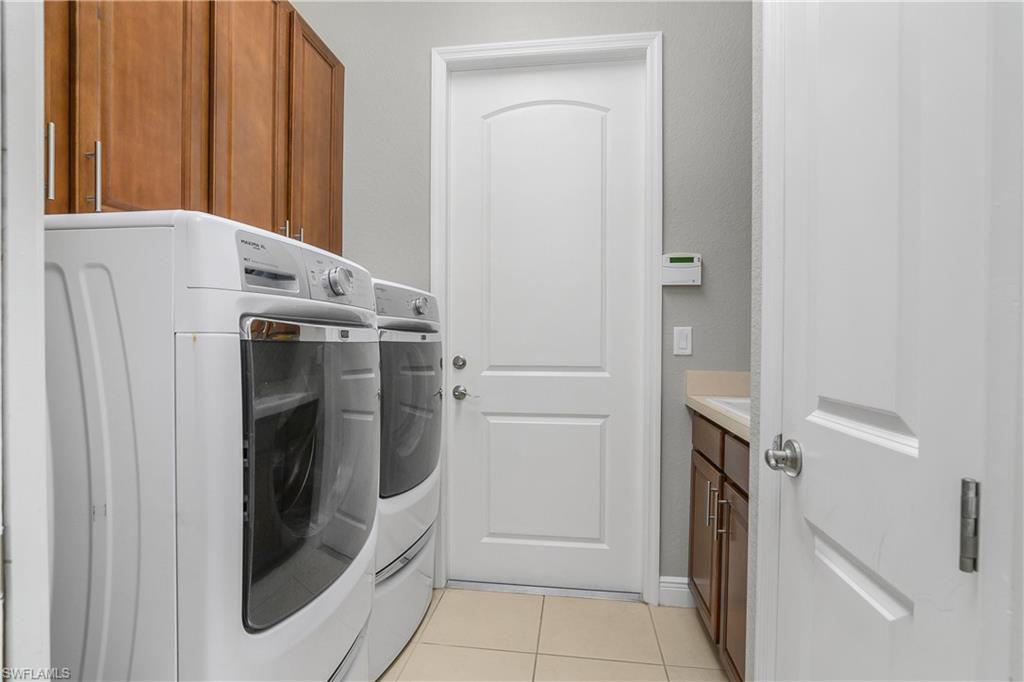 1558 Serrano Circle Naples, FL 34105 - Photo 22 of 31 a view of a storage and utility room with washer and dryer