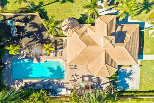 front view of a house with a yard and potted plants
