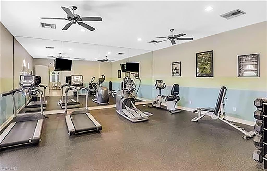 1558 Serrano Circle Naples, FL 34105 - Photo 29 of 31 a view of a room with gym equipment