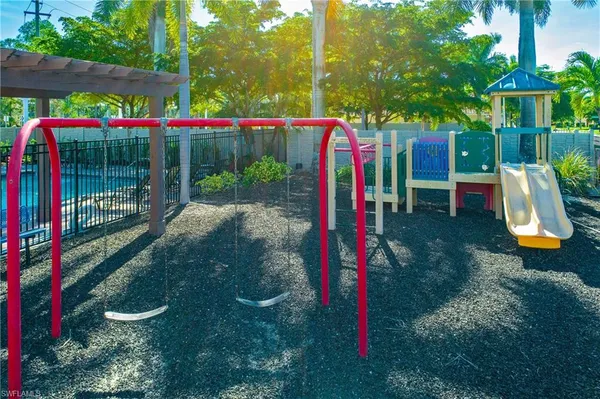 a view of a park with swings and slides