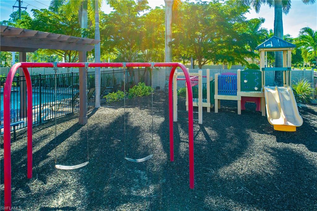 1558 Serrano Circle Naples, FL 34105 - Photo 31 of 31 a view of a park with swings and slides