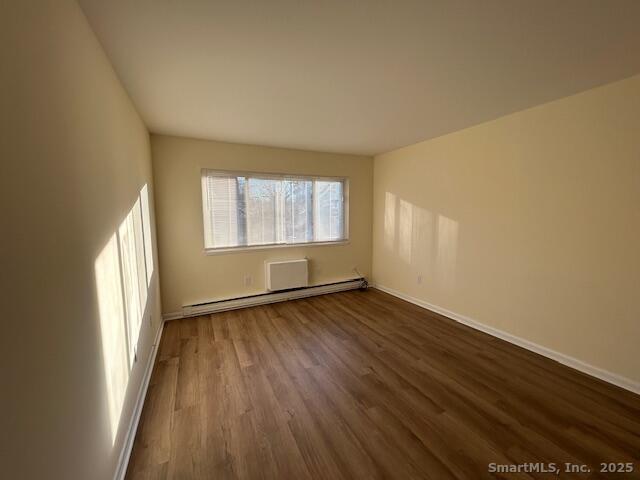 5 West Washington Avenue, Unit 7 Stamford, CT 06902 - Photo 1 of 9 an empty room with wooden floor and windows