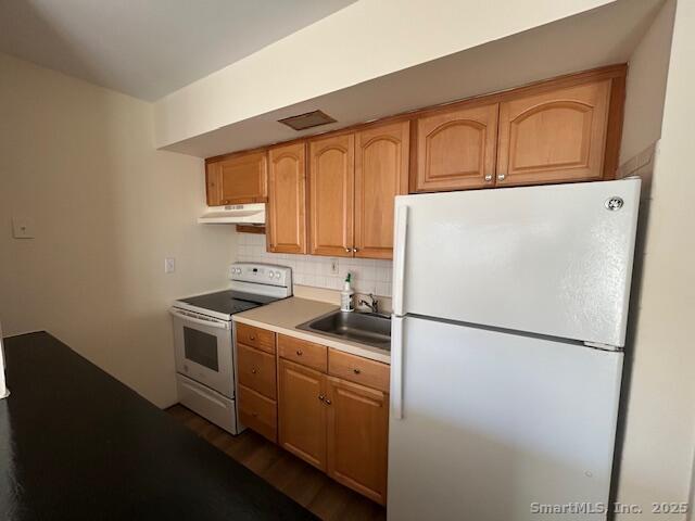 5 West Washington Avenue, Unit 7 Stamford, CT 06902 - Photo 3 of 9 a kitchen with a refrigerator sink stove and cabinets