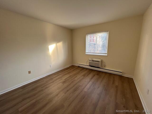 5 West Washington Avenue, Unit 7 Stamford, CT 06902 - Photo 5 of 9 an empty room with wooden floor and windows