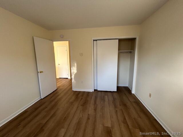 5 West Washington Avenue, Unit 7 Stamford, CT 06902 - Photo 6 of 9 an empty room with wooden floor and closet