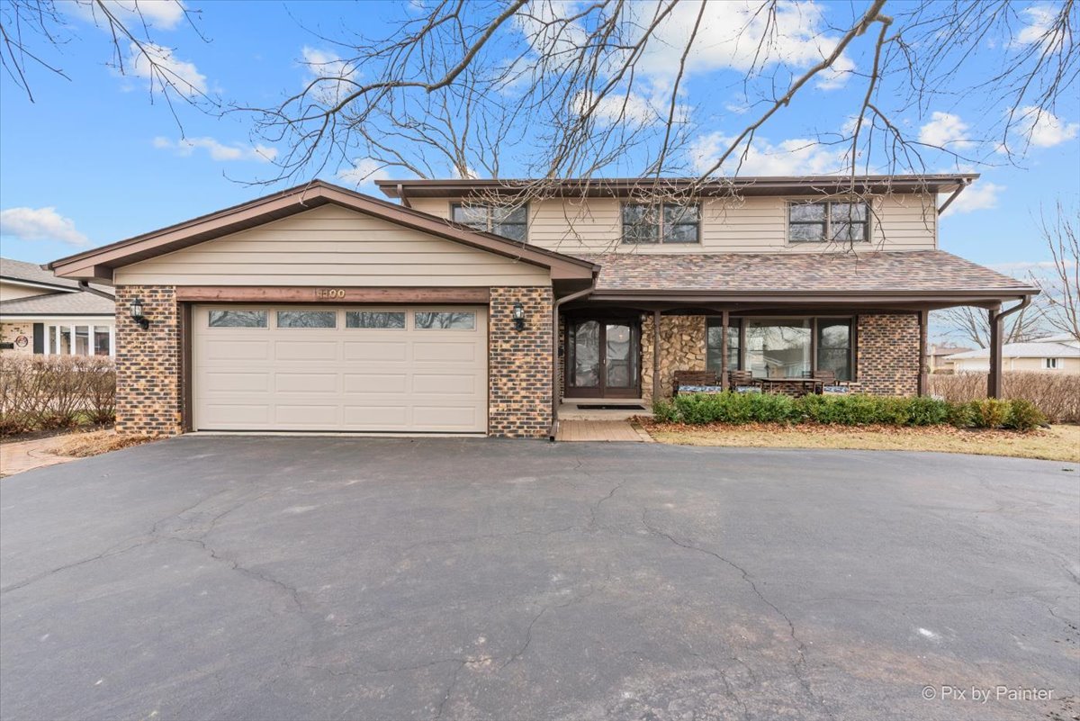 1100 South Church Road Mount Prospect, IL 60056 - Photo 1 of 50 a front view of a house with a yard and garage