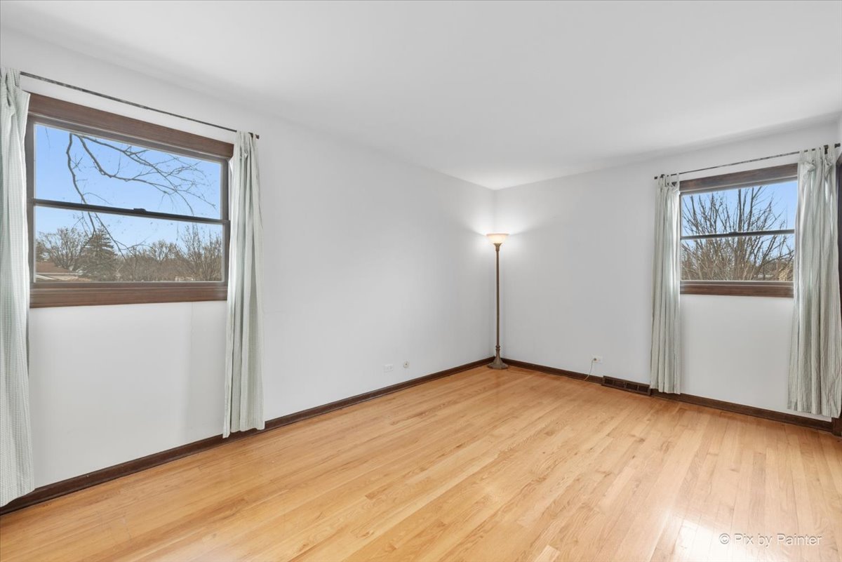 1100 South Church Road Mount Prospect, IL 60056 - Photo 21 of 50 a view of an empty room with wooden floor and a window