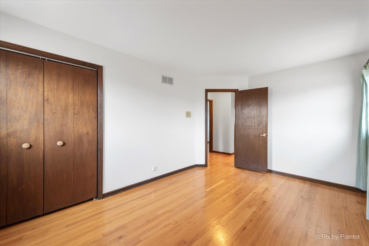 1100 South Church Road Mount Prospect, IL 60056 - Photo 22 of 50 a view of an empty room with wooden floor and closet