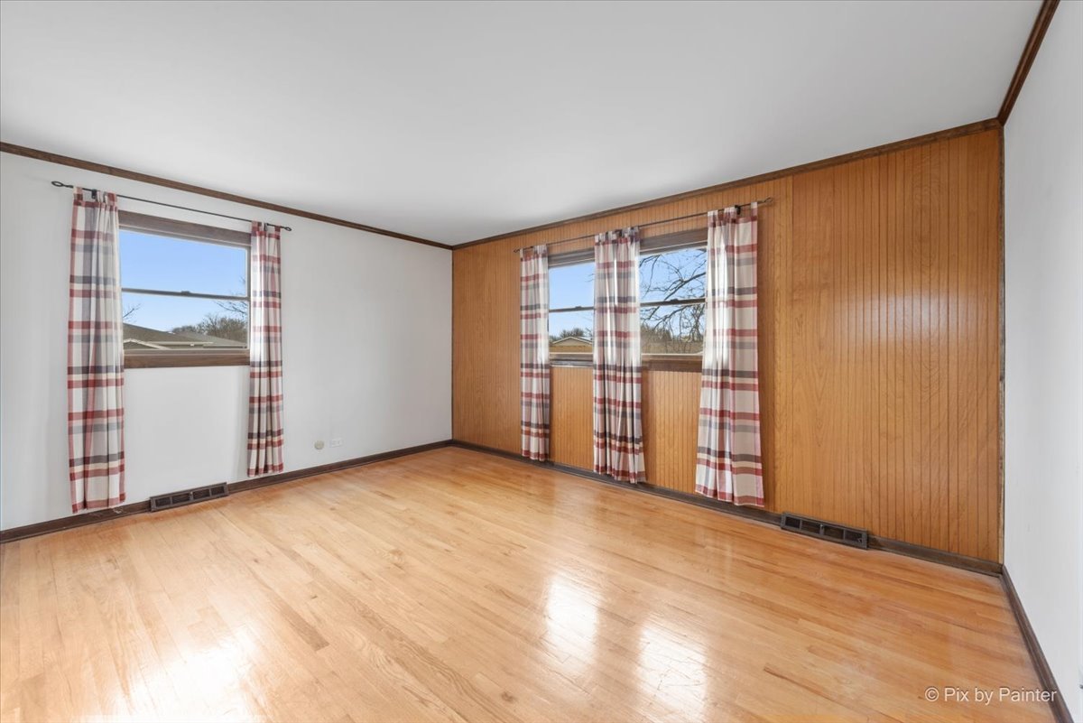 1100 South Church Road Mount Prospect, IL 60056 - Photo 23 of 50 an empty room with wooden floor and sliding door