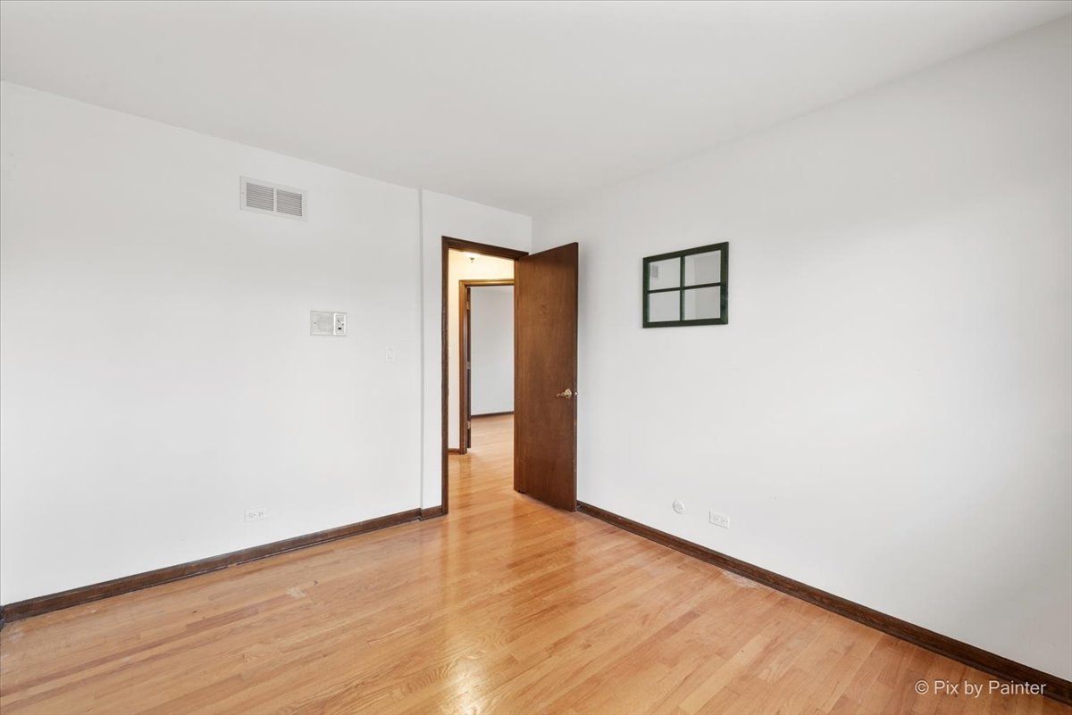 1100 South Church Road Mount Prospect, IL 60056 - Photo 26 of 50 a view of an empty room with wooden floor and a window