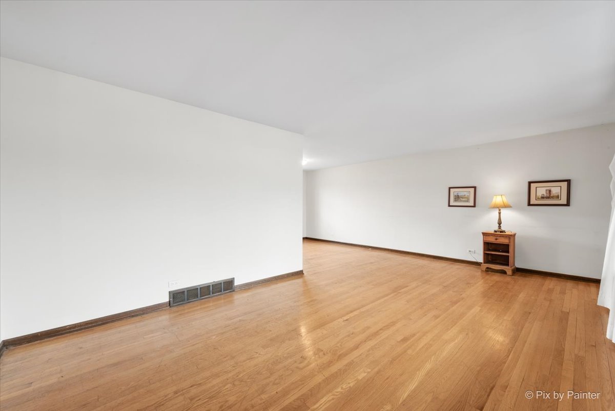1100 South Church Road Mount Prospect, IL 60056 - Photo 3 of 50 a view of a room with wooden floor and a table