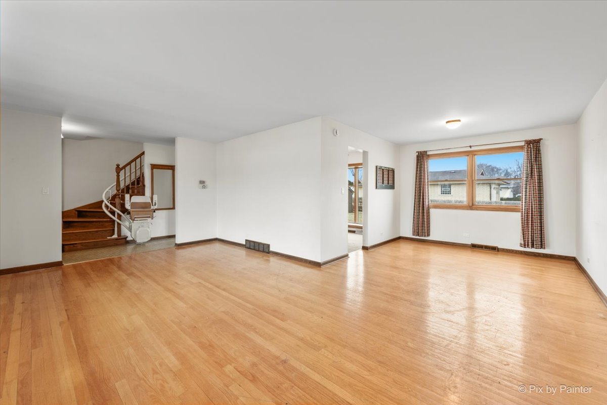 1100 South Church Road Mount Prospect, IL 60056 - Photo 4 of 50 a view of empty room with wooden floor and fan