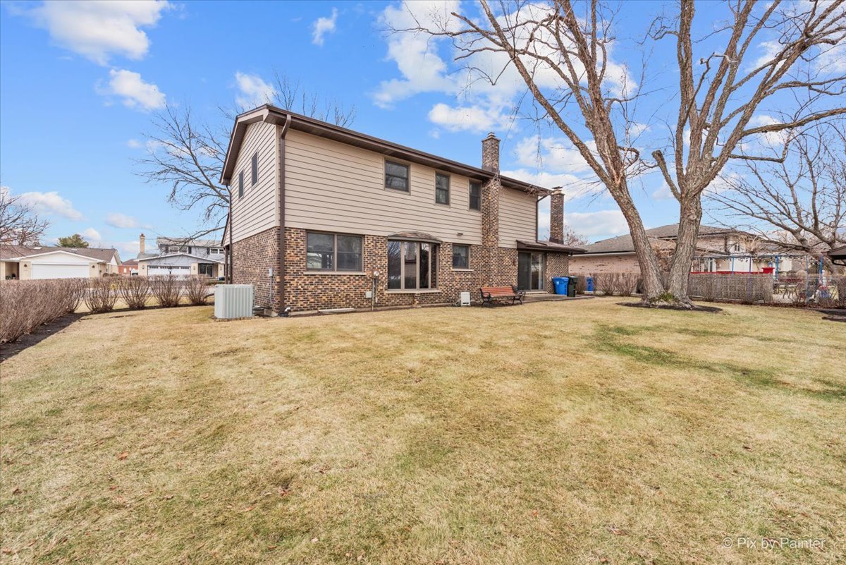 1100 South Church Road Mount Prospect, IL 60056 - Photo 48 of 50 a view of a white house with a yard covered in snow