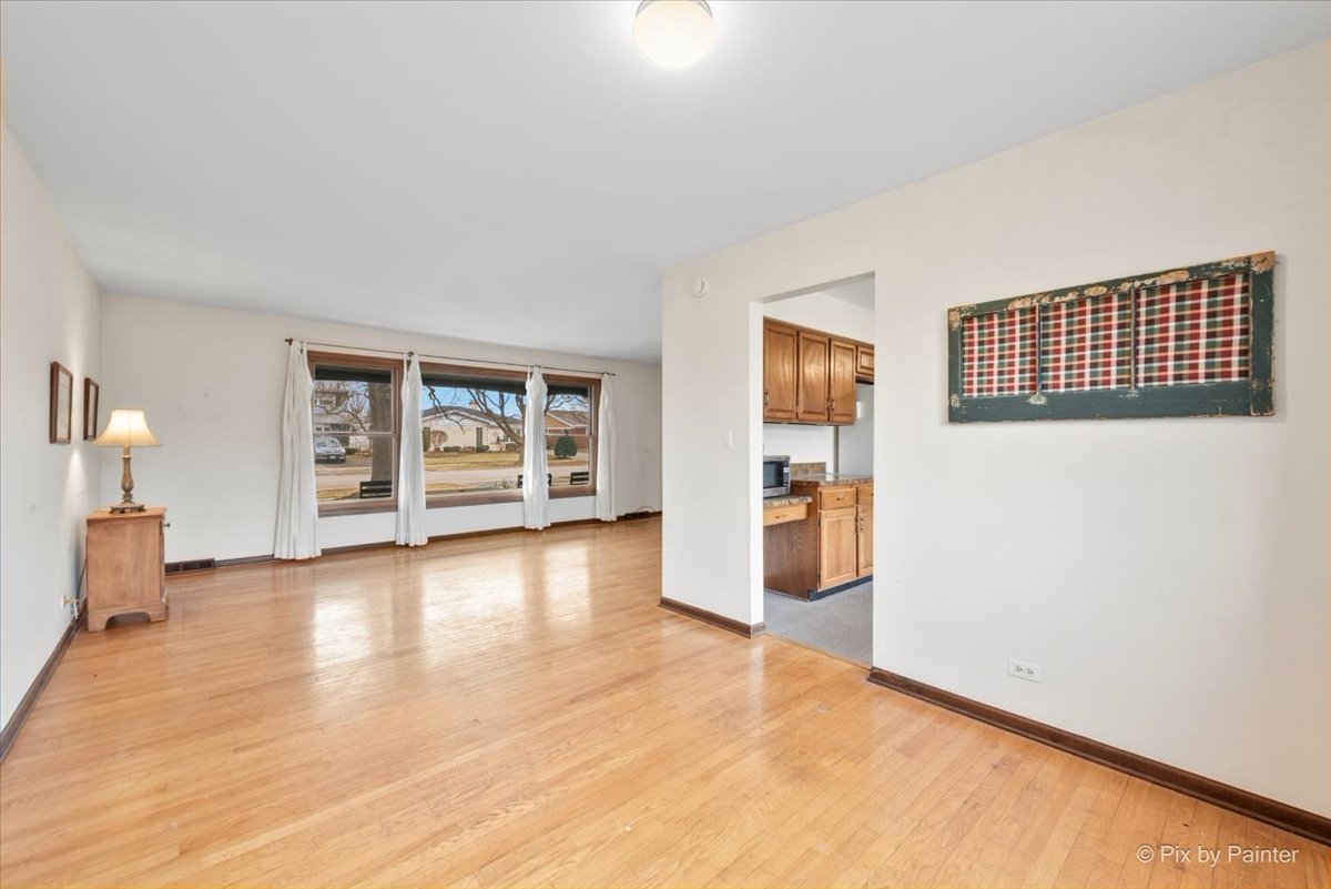 1100 South Church Road Mount Prospect, IL 60056 - Photo 7 of 50 wooden floor in an empty room with a window
