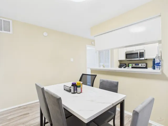 a kitchen with stainless steel appliances a microwave a sink and a refrigerator