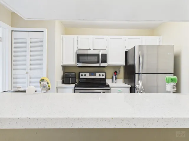 a kitchen with stainless steel appliances a sink stove and microwave
