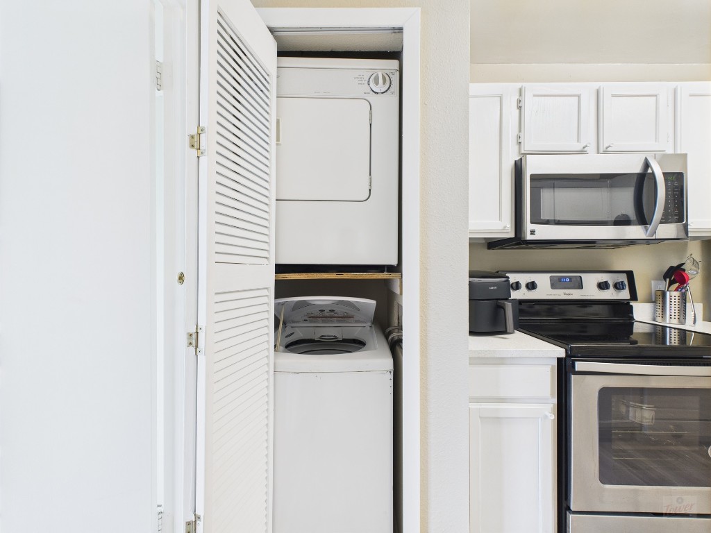 3115 Helms Street, Unit 202 Austin, TX 78705 - Photo 21 of 26 a kitchen with a microwave and a stove