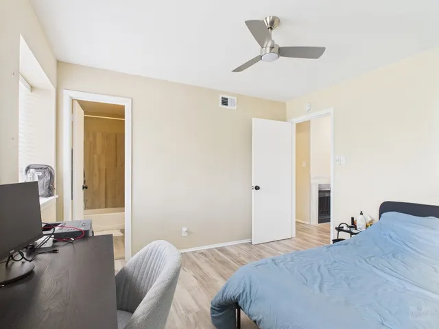 a bathroom with a sink a toilet and shower curtain