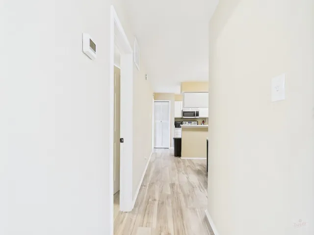 a bathroom with a toilet sink vanity and mirror
