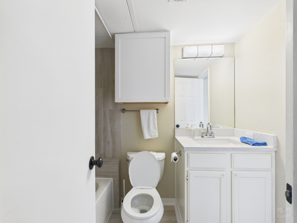 3115 Helms Street, Unit 202 Austin, TX 78705 - Photo 9 of 26 a bathroom with a toilet sink vanity and mirror