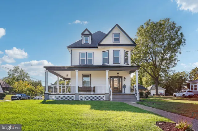 a view of a house with a yard porch and sitting area