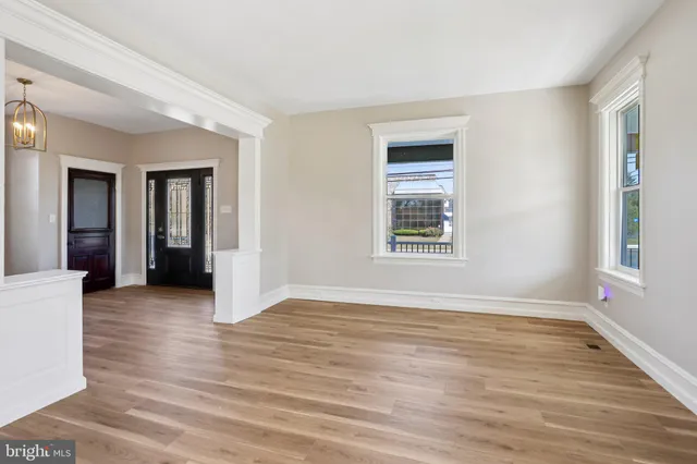 a kitchen with stainless steel appliances a sink cabinets and wooden floor