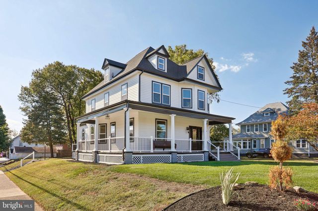 a view of a house with a swimming pool and a yard