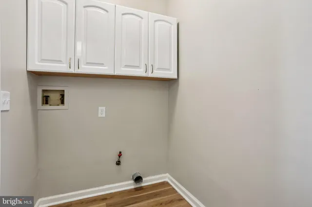 a bedroom with bed and wooden floor