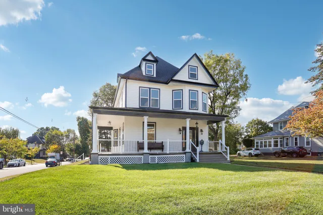 a view of a livingroom with wooden floor and stairs