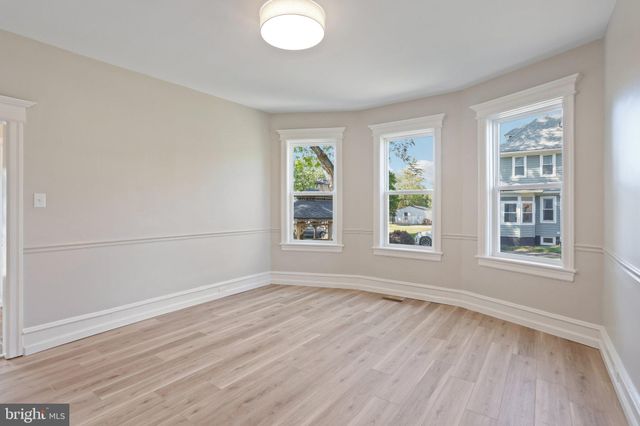 a bedroom with a large bed and a flat tv screen