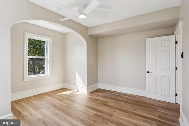 a view of a hallway with wooden floor and entryway