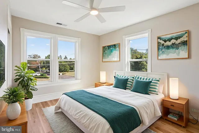 a view of a house with a big yard plants and large trees