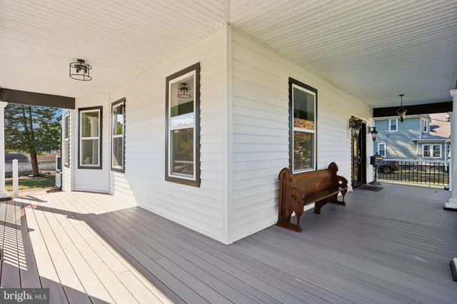 a view of an entryway with wooden floor and a front door