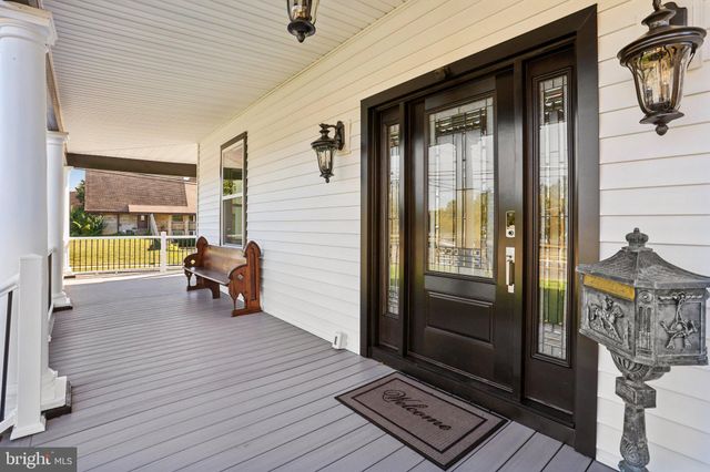 a living room with furniture potted plant and a window