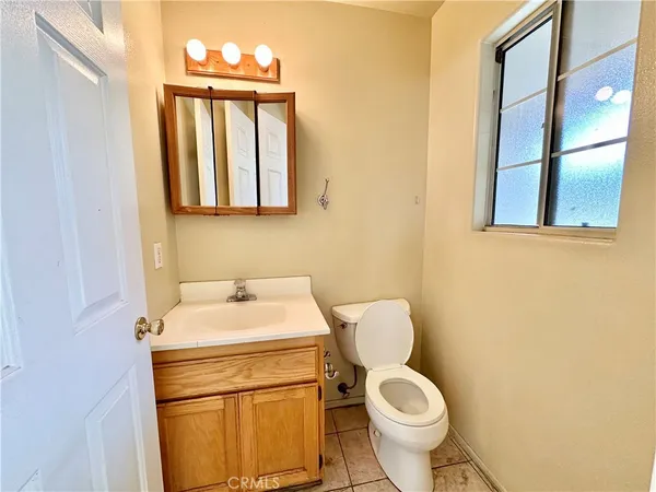 a kitchen with stainless steel appliances granite countertop a stove top oven a sink a counter top space and cabinets