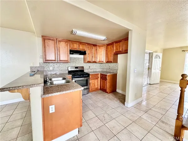 a view of a kitchen with wooden floor and a sink