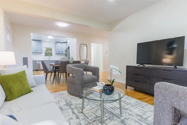 a view of a room with wooden floor washer and dryer
